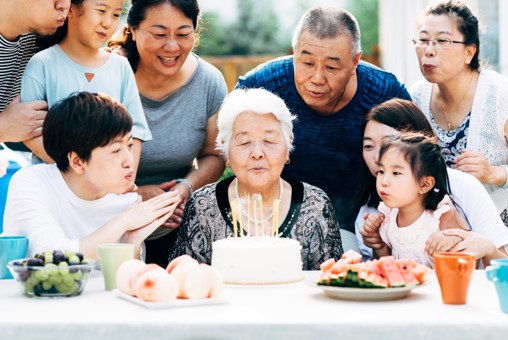 a group of people sitting at a table with food